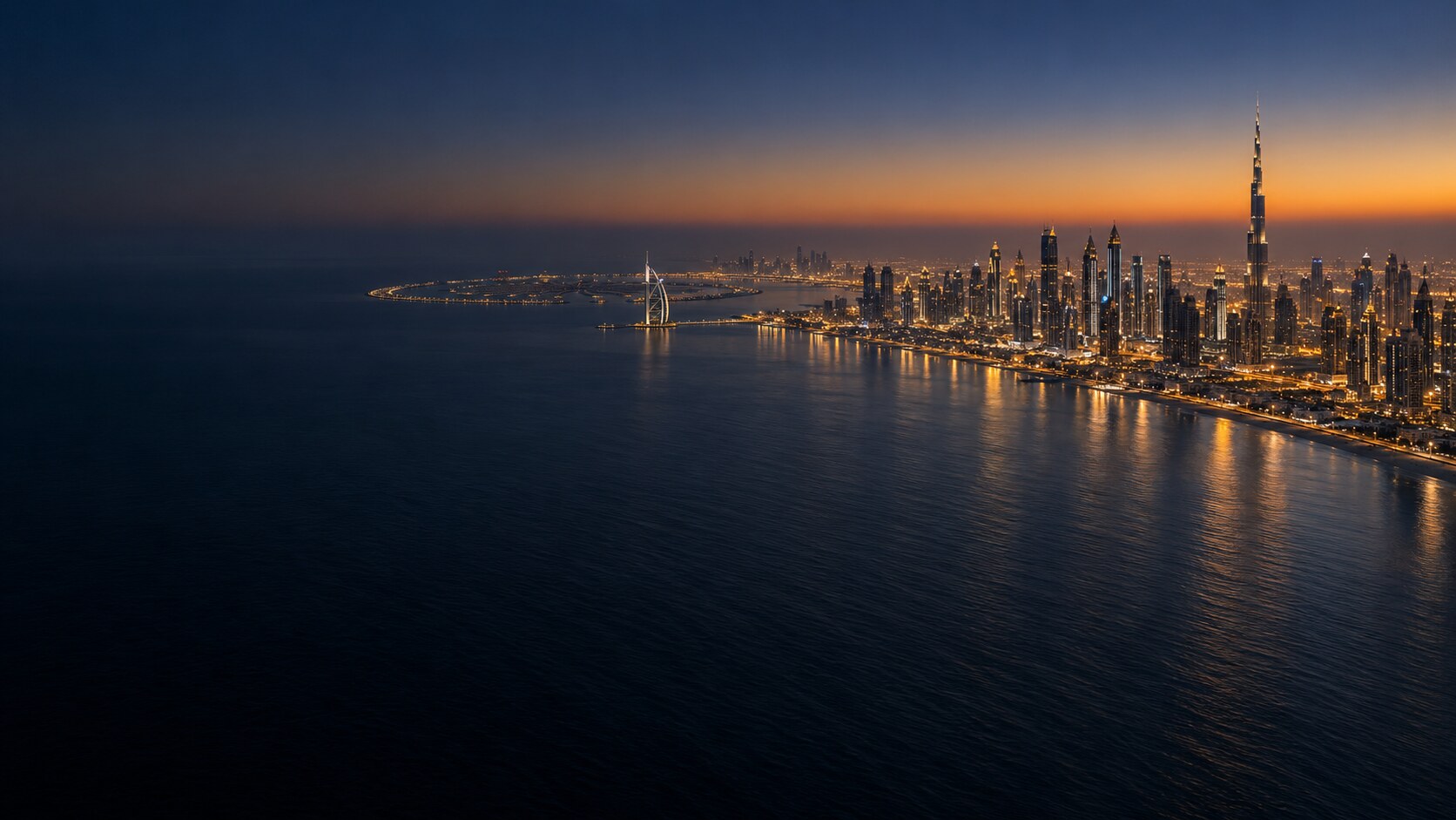 Dubai coastline seen from above at blue hour, towers glowing along the shore